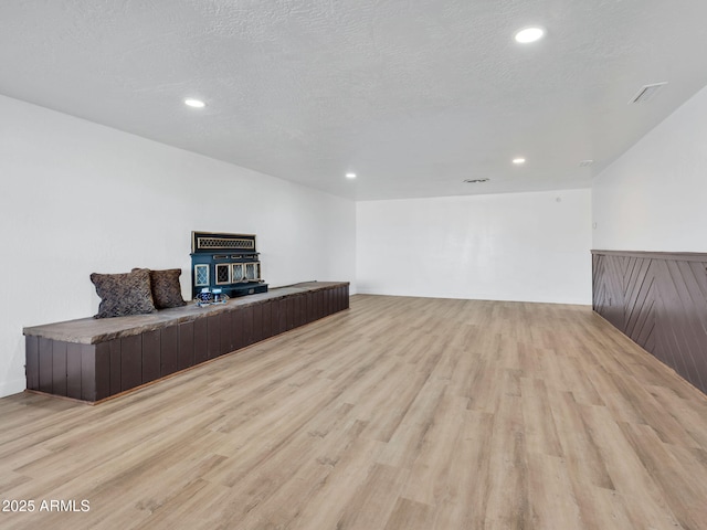 office space featuring recessed lighting, a textured ceiling, and light wood finished floors