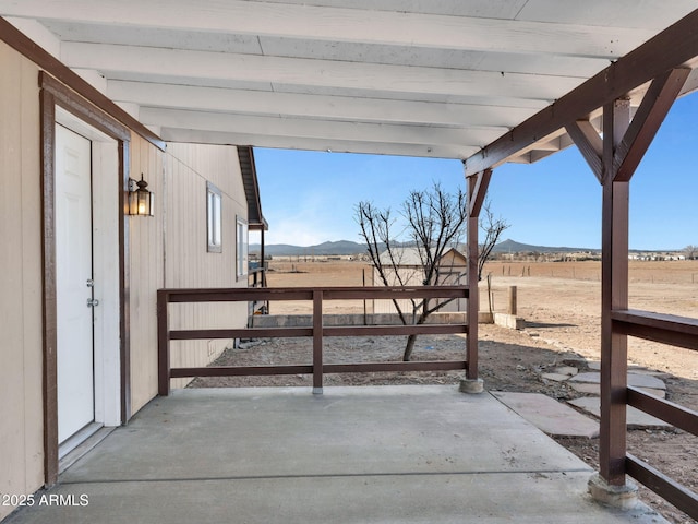 view of patio / terrace with a rural view and a mountain view