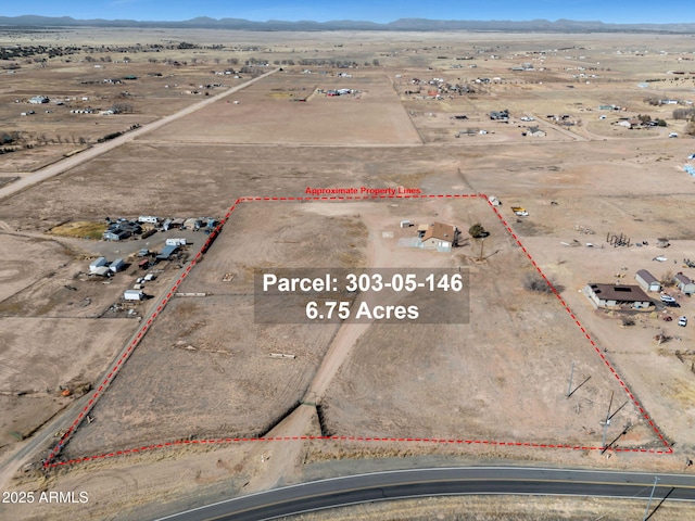 birds eye view of property with a mountain view, a desert view, and a rural view