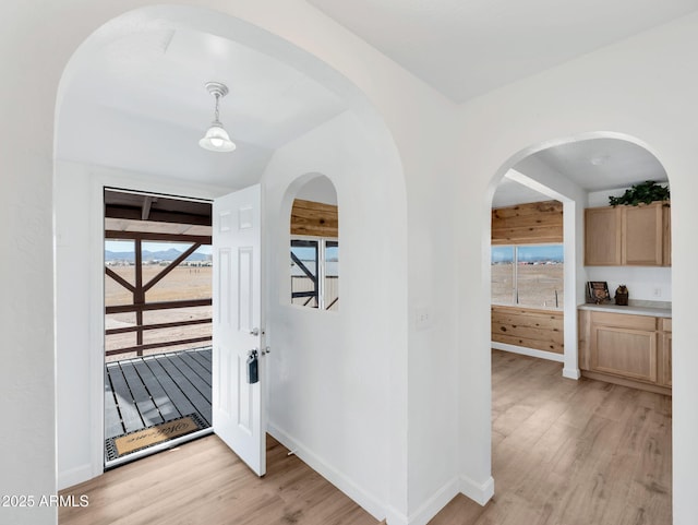 entrance foyer with light wood-style flooring and baseboards