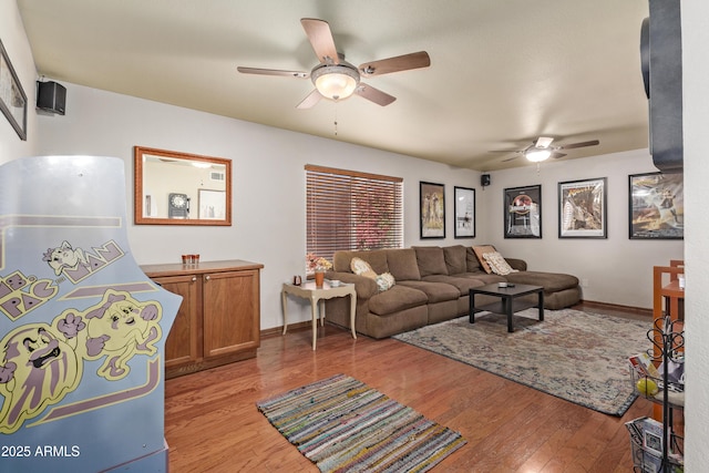 living room featuring ceiling fan and light wood-type flooring