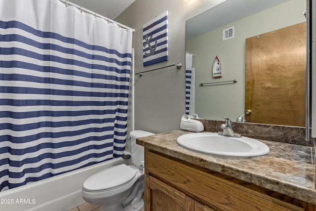 full bathroom with shower / tub combo with curtain, vanity, and toilet