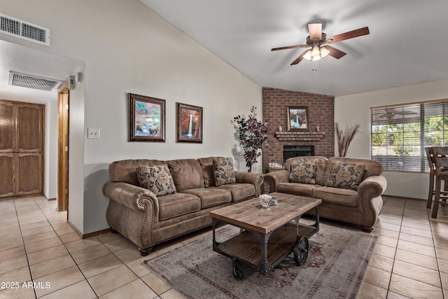 living room featuring ceiling fan, a fireplace, light tile patterned floors, and lofted ceiling