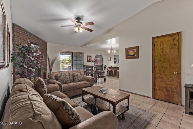 living room featuring light tile patterned floors, ceiling fan with notable chandelier, and vaulted ceiling