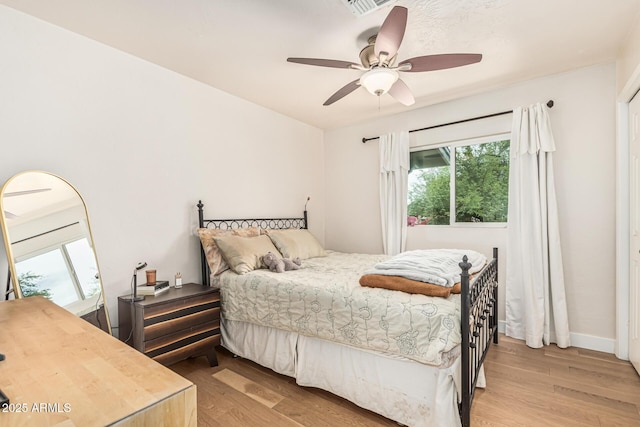 2019 W Stella Ln, Phoenix, AZ 85015 - bedroom featuring light wood finished floors and a ceiling fan