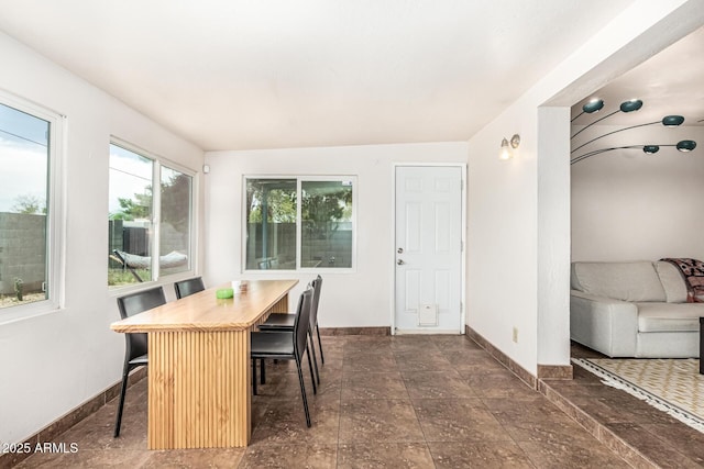 2019 W Stella Ln, Phoenix, AZ 85015 - dining space featuring baseboards and dark stone finish floors