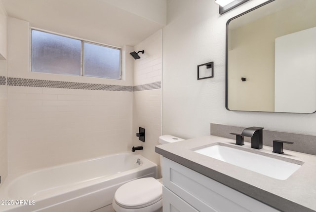 full bathroom with toilet, vanity, and tiled shower / bath