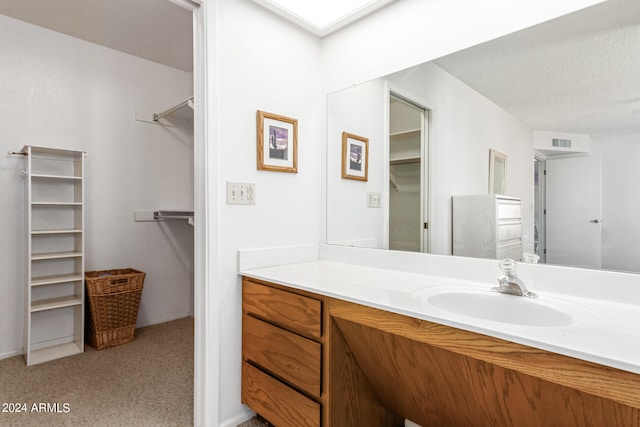 bathroom featuring vanity and a textured ceiling