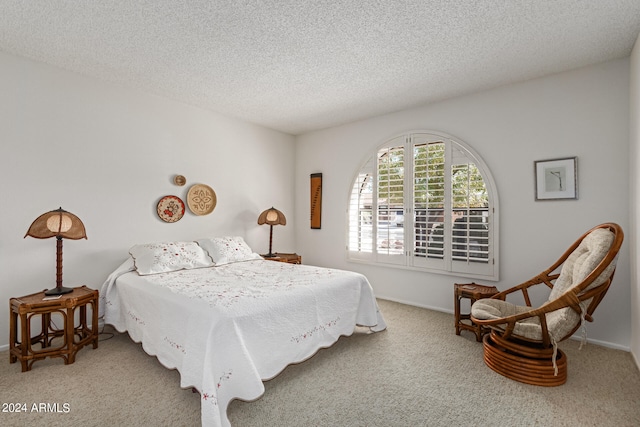 bedroom featuring carpet floors and a textured ceiling