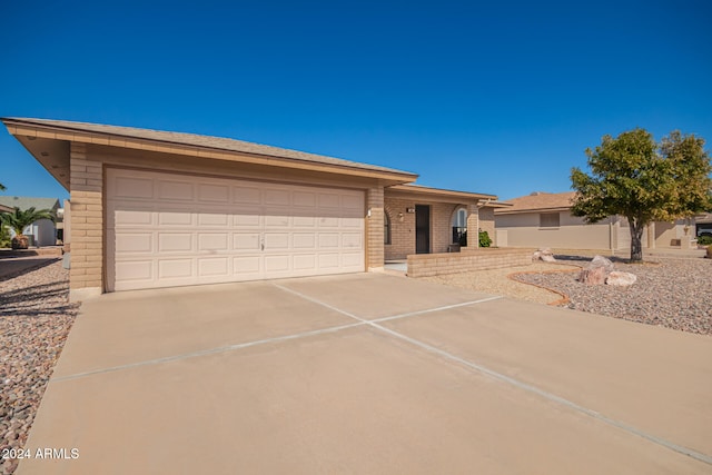 ranch-style home featuring a garage