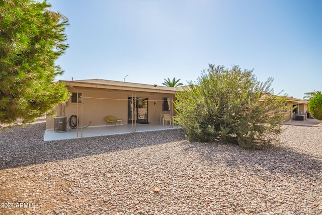 rear view of property featuring central air condition unit and a patio