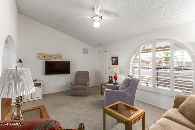 carpeted living room featuring lofted ceiling, a textured ceiling, and ceiling fan