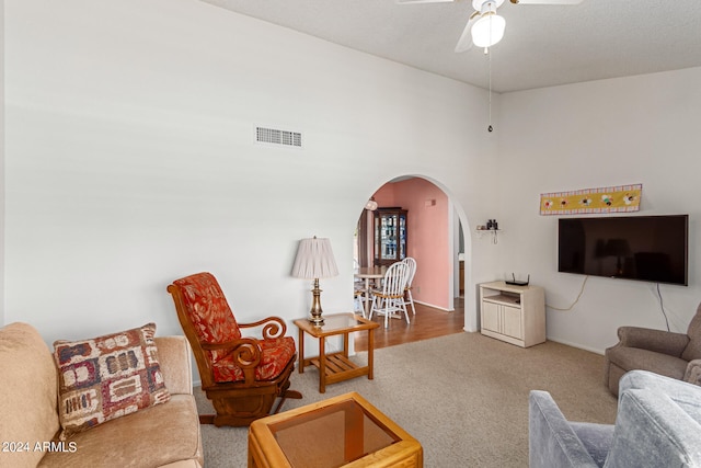 living room with ceiling fan and hardwood / wood-style flooring