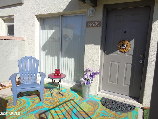 entrance to property with stucco siding