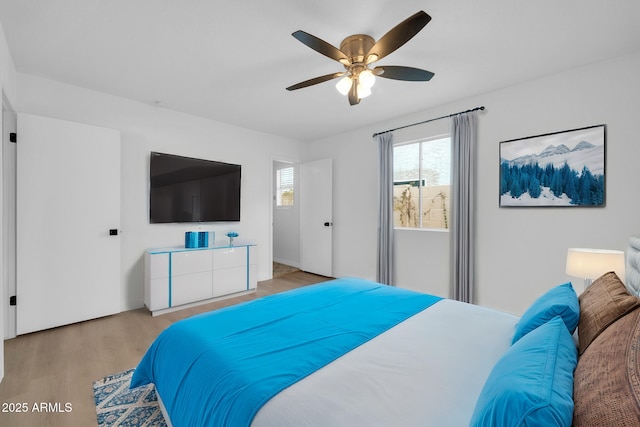 bedroom featuring light wood finished floors and a ceiling fan