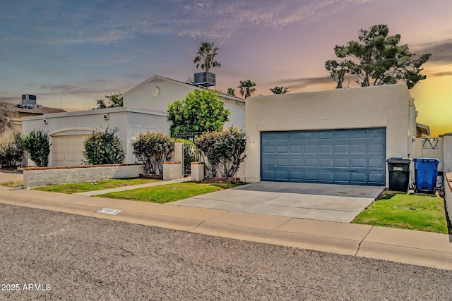 view of front facade featuring an attached garage, driveway, and stucco siding