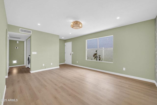 empty room with light wood-type flooring, visible vents, baseboards, and recessed lighting