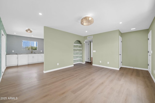 unfurnished living room featuring recessed lighting, light wood-style floors, visible vents, and baseboards