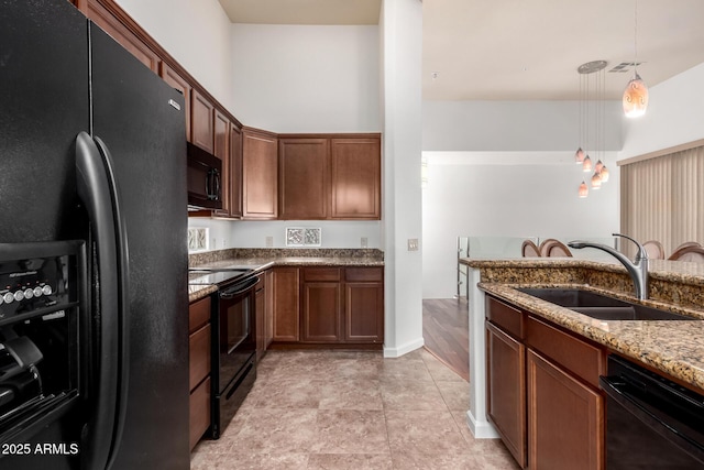 20801 N 90th Pl Unit 210, Scottsdale, AZ 85255 - kitchen with a sink, dark stone counters, visible vents, pendant lighting, and black appliances
