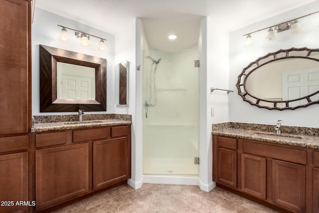 20801 N 90th Pl Unit 210, Scottsdale, AZ 85255 - bathroom featuring a sink, a shower stall, and two vanities
