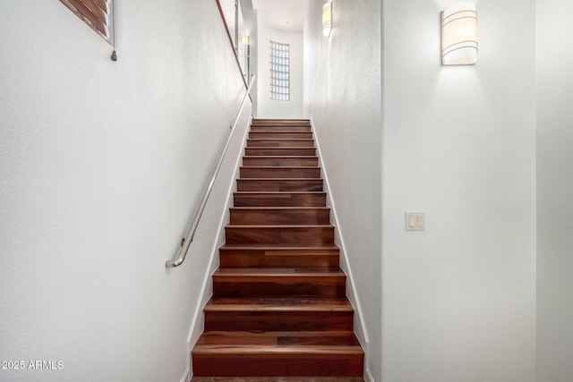 20801 N 90th Pl Unit 210, Scottsdale, AZ 85255 - staircase featuring baseboards and a high ceiling