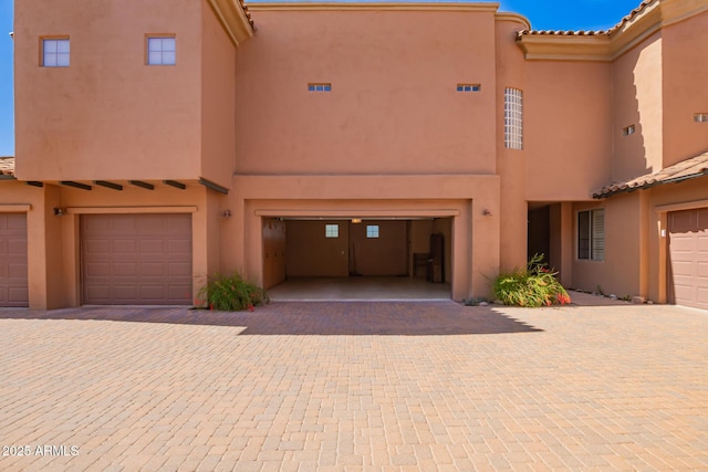 20801 N 90th Pl Unit 210, Scottsdale, AZ 85255 - view of front facade with an attached garage, stucco siding, a tiled roof, and driveway