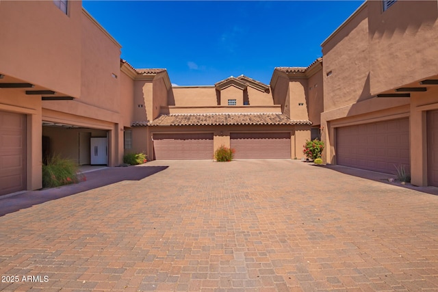 20801 N 90th Pl Unit 210, Scottsdale, AZ 85255 - view of front of home with stucco siding, driveway, and a tile roof
