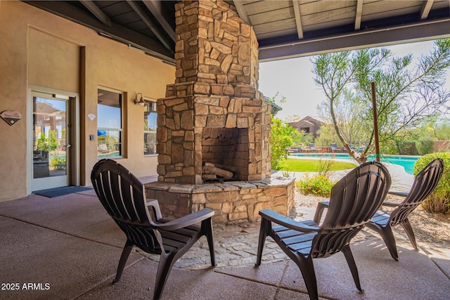 20801 N 90th Pl Unit 210, Scottsdale, AZ 85255 - view of patio with an outdoor stone fireplace and an outdoor pool