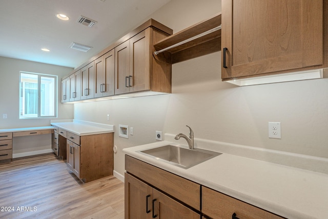 kitchen with light wood-type flooring and sink