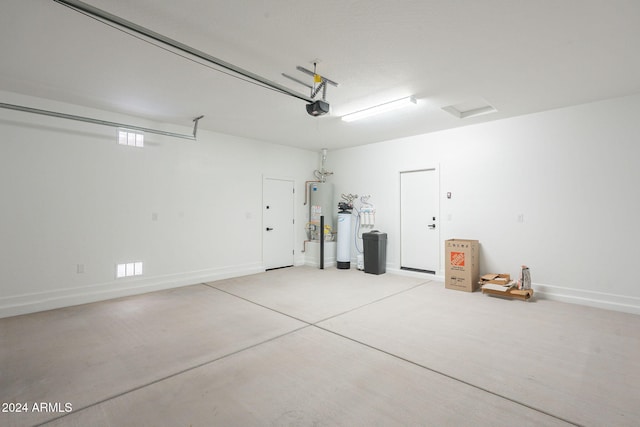 garage with a garage door opener and gas water heater