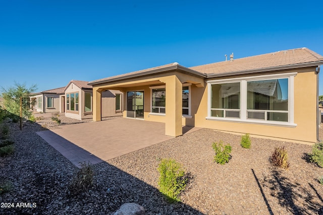 back of house with a patio