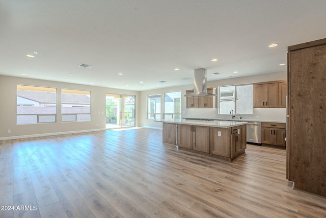 kitchen featuring island exhaust hood, light hardwood / wood-style flooring, a center island, and appliances with stainless steel finishes