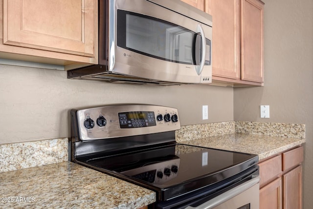 kitchen with appliances with stainless steel finishes and light brown cabinetry