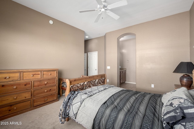 carpeted bedroom featuring ceiling fan and ensuite bathroom