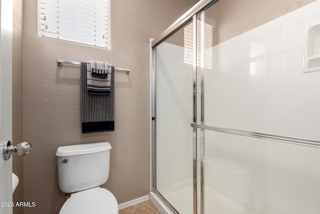 bathroom featuring toilet and walk in shower