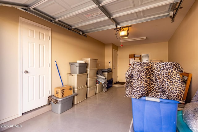 garage with electric panel and a garage door opener