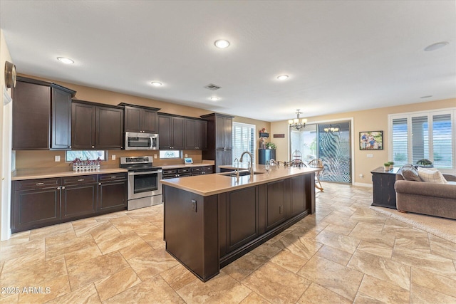 kitchen featuring visible vents, dark brown cabinets, a chandelier, light countertops, and stainless steel appliances