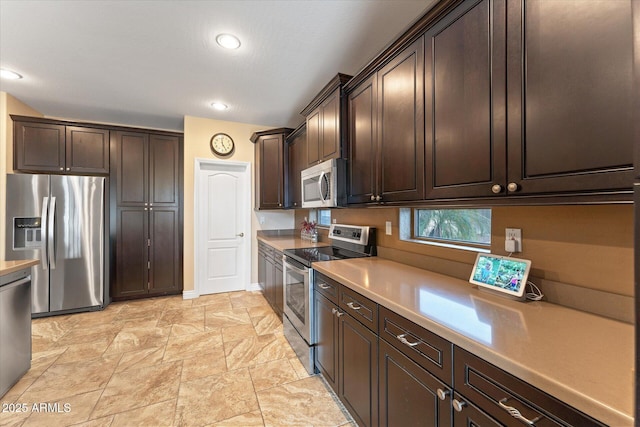 kitchen with recessed lighting, dark brown cabinets, appliances with stainless steel finishes, and light countertops