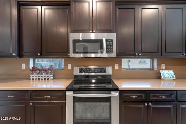 kitchen with light countertops, dark brown cabinetry, and stainless steel appliances