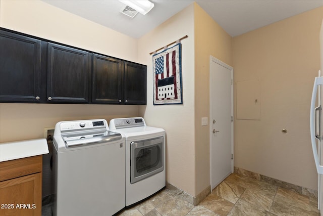 clothes washing area featuring visible vents, cabinet space, separate washer and dryer, and baseboards