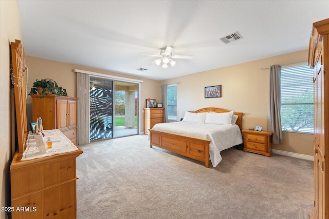 bedroom with access to exterior, visible vents, multiple windows, and light carpet