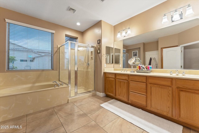 bathroom featuring visible vents, a sink, a shower stall, double vanity, and a bath