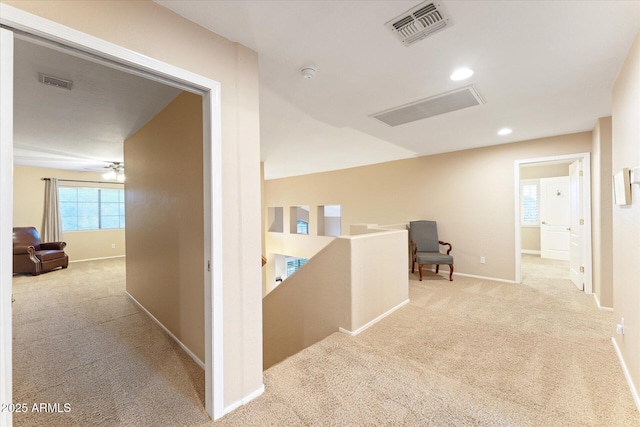 corridor with recessed lighting, visible vents, baseboards, and carpet flooring