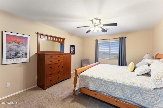 bedroom with light colored carpet, baseboards, and ceiling fan