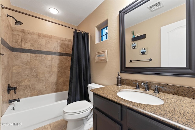 full bathroom featuring vanity, visible vents, shower / tub combo, toilet, and a textured wall