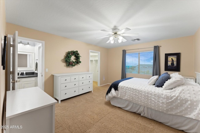 bedroom with visible vents, ceiling fan, a spacious closet, a closet, and light carpet