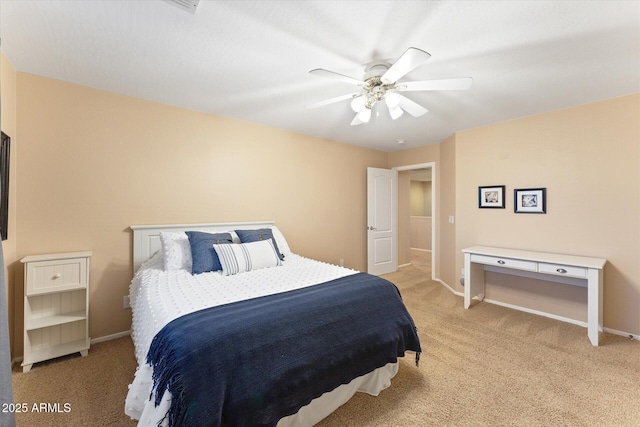 bedroom featuring baseboards, light carpet, and a ceiling fan