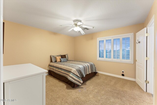 bedroom with visible vents, baseboards, light colored carpet, and a ceiling fan