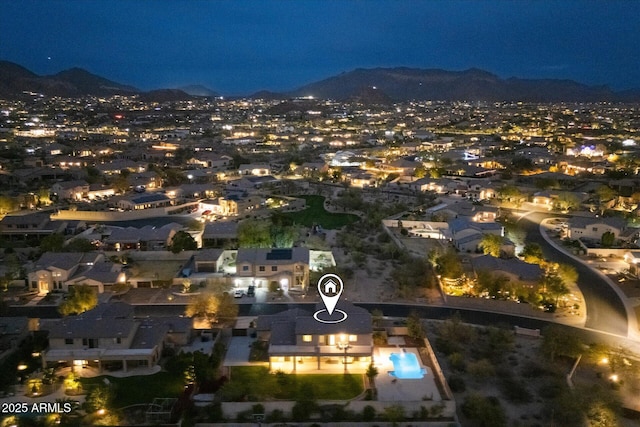 aerial view at twilight featuring a mountain view