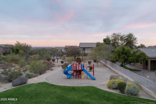 community play area with a yard and fence